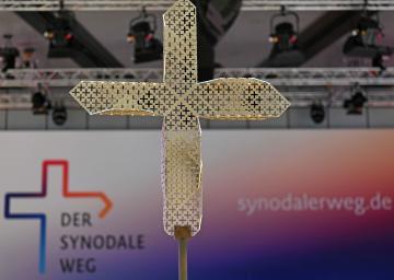 Kreuz vor einem Banner des Synodalen Wegs